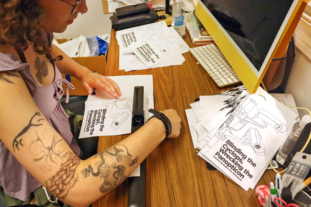 Sula Macdonald makes zines for the SUNSCAD Zine Press at NSCAD University on Duke Street in Halifax, Nova Scotia on September 23, 2025. They use a long-arm stapler to bind the zines.