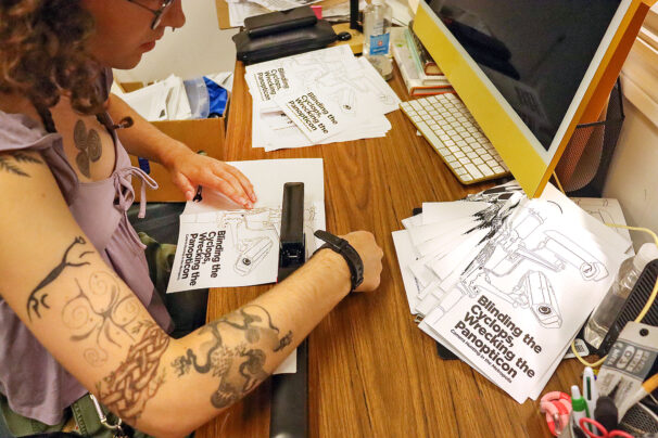 Sula Macdonald makes zines for the SUNSCAD Zine Press at NSCAD University on Duke Street in Halifax, Nova Scotia on September 23, 2025. They use a long-arm stapler to bind the zines.