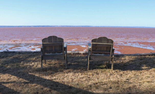 Two wooden chairs face the Cobequid Bay outside Ralph Wardrope’s cottage in Bass River, N.S.