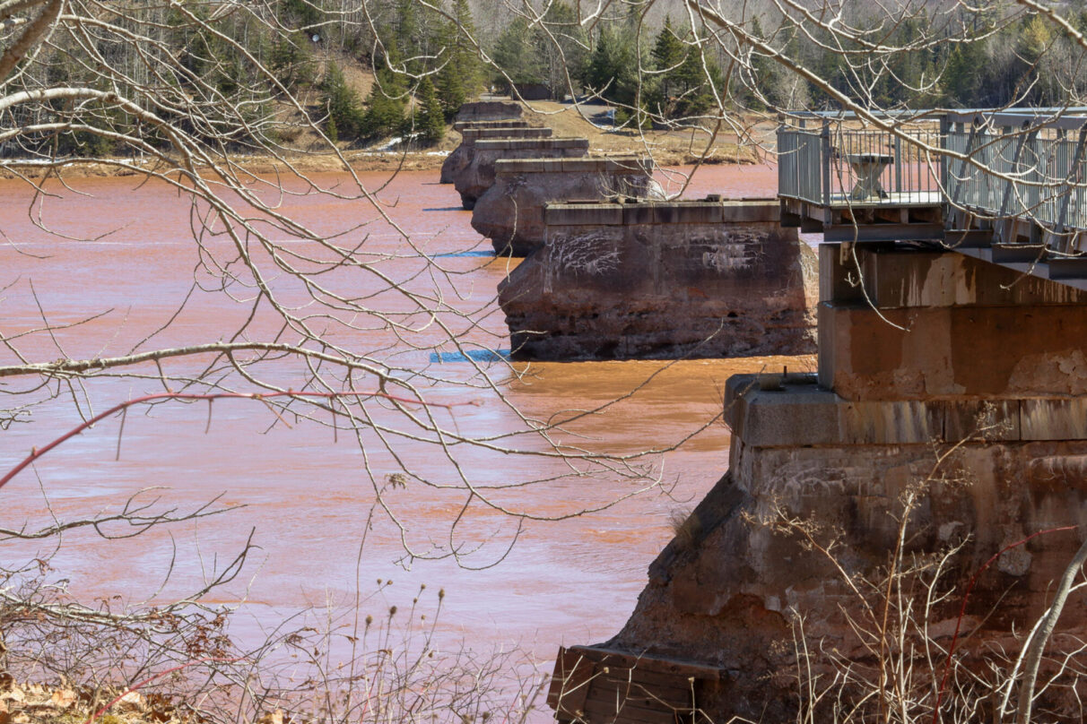 The eroded pillars of an old rail bridge spanning the muddy waters of the Shubenacadie River near Maitland, N.S., are pictured.