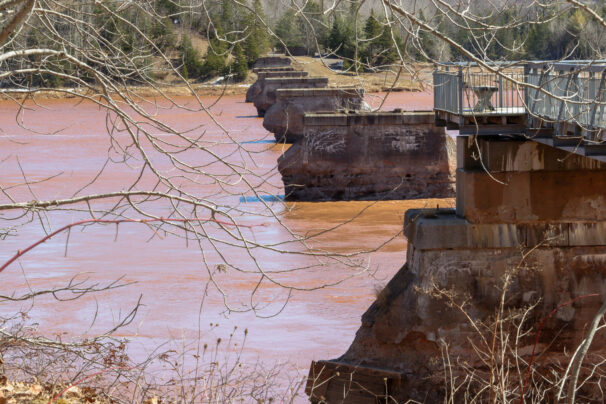 The eroded pillars of an old rail bridge spanning the muddy waters of the Shubenacadie River near Maitland, N.S., are pictured.