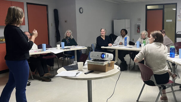 Attendees at the community workshop listen to Emily Cowin speaking.