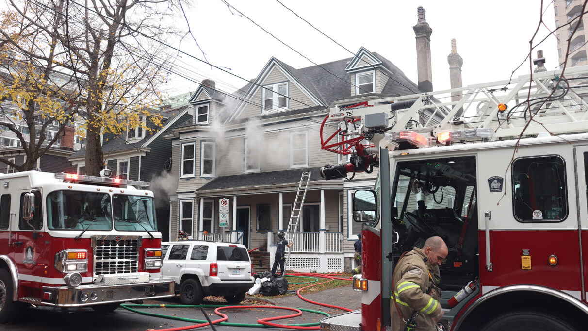 Firefighters ready their gear and place a ladder in front of the house to put out othe fire. Halifax Nov. 17