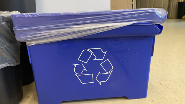 A blue recycling bin in the King's Student Union office