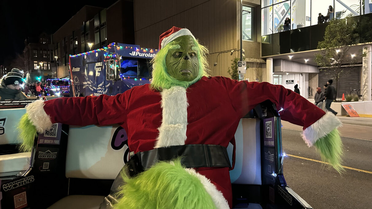 A Grinch costume sitting on a rickshaw.