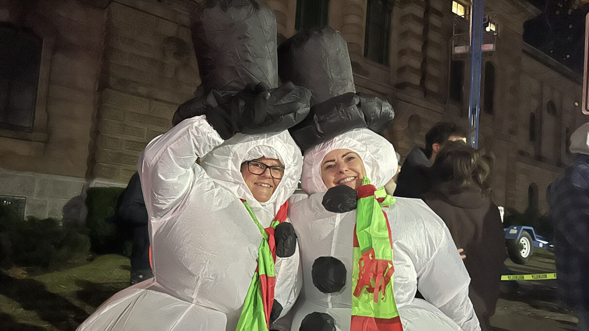 Two women dressed as snowpeople.