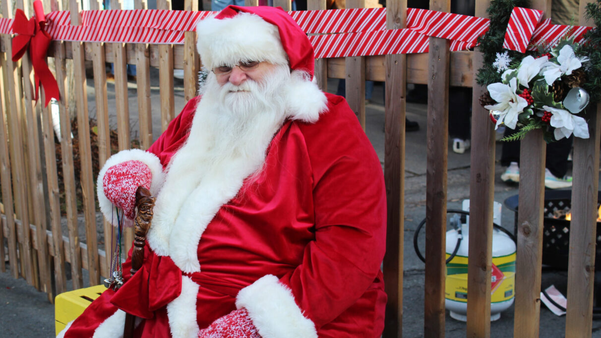 Santa sitting at the Agricola Holiday Market.