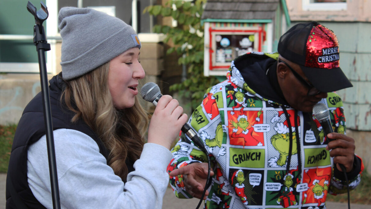 Reaghan Moore and Marcell Symonds singing at the Agricola Street Holiday Market.