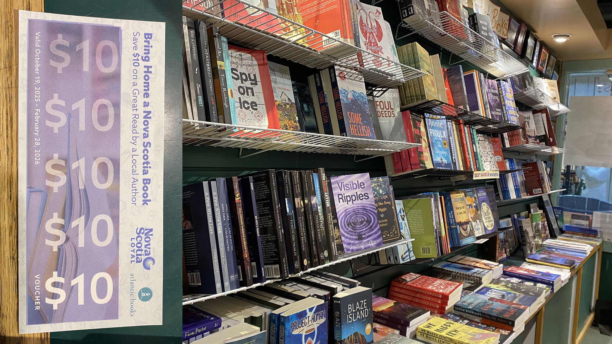 A shelf full to the brim of books, with an inlaid photo of the $10 loyal book program voucher.