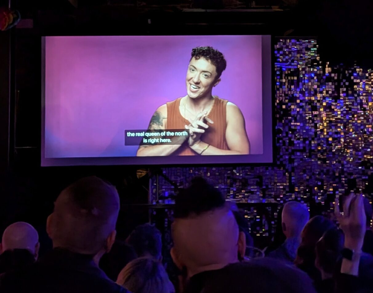 The Stardust Bar + Kitchen in Halifax, Nova Scotia was hosting Canada’s Drag Race Season 6 premier viewing party episode one. Dillon Ross, the person behind the artist Mya Foxx is seen here on the large viewing screen as the crowd watches the first episode.