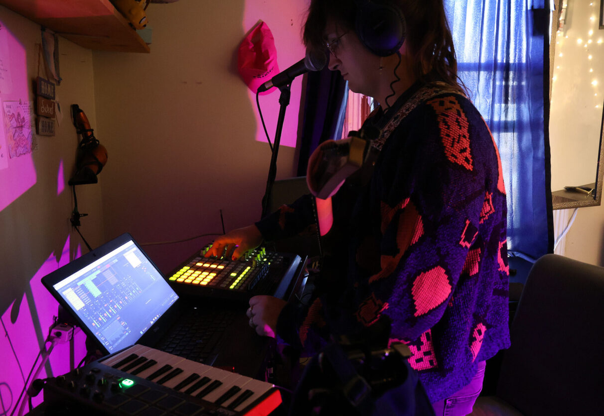 Lydia composing in her room which serves as her musical lab. As a solo artist -EMBEDME reflects her lived experiences and working with other local musicians to collaborate. Here, she writes, composes, and records.
