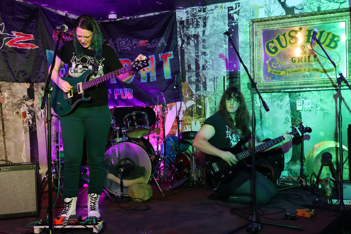 Soundcheck at Gus Pub sin the North end sees Lydia, a core member of Amygdala Hijack, working alongside her bandmates. With the venue’s long history in Halifax’s punk and metal scene, this all-female trio gets ready to take the stage with a performance that embodies riot girl power and rebellion.