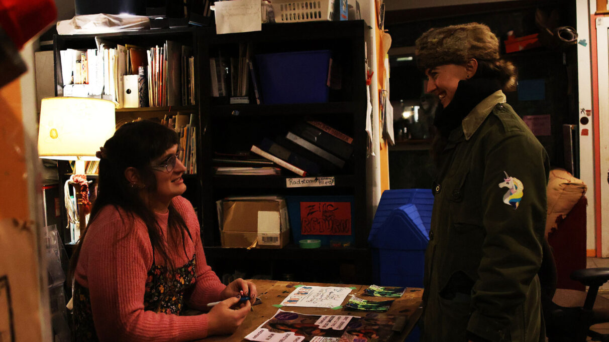 At RadStorm, in Halifax's north end Lydia meets fans at the merch booth, with new EMBEDME stickers and CDs. The venue, a vital part of Halifax’s underground scene, has long been a space for artistic collaboration, activism, and promoting creative and cultural activities through a DIY approach.