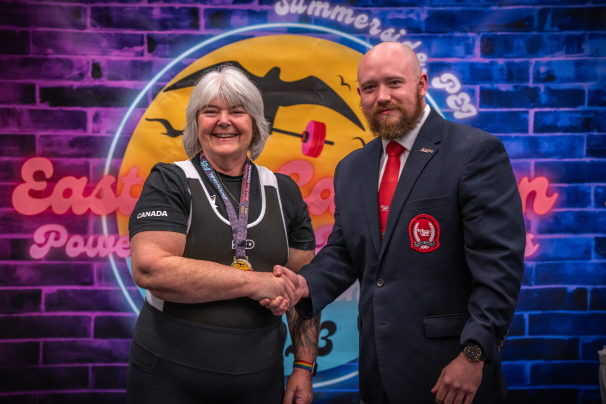 Sue Bonneau shakes hands with Justin Smith at the 2023 CPU Eastern Powerlifting Championships in Summerside, PEI.