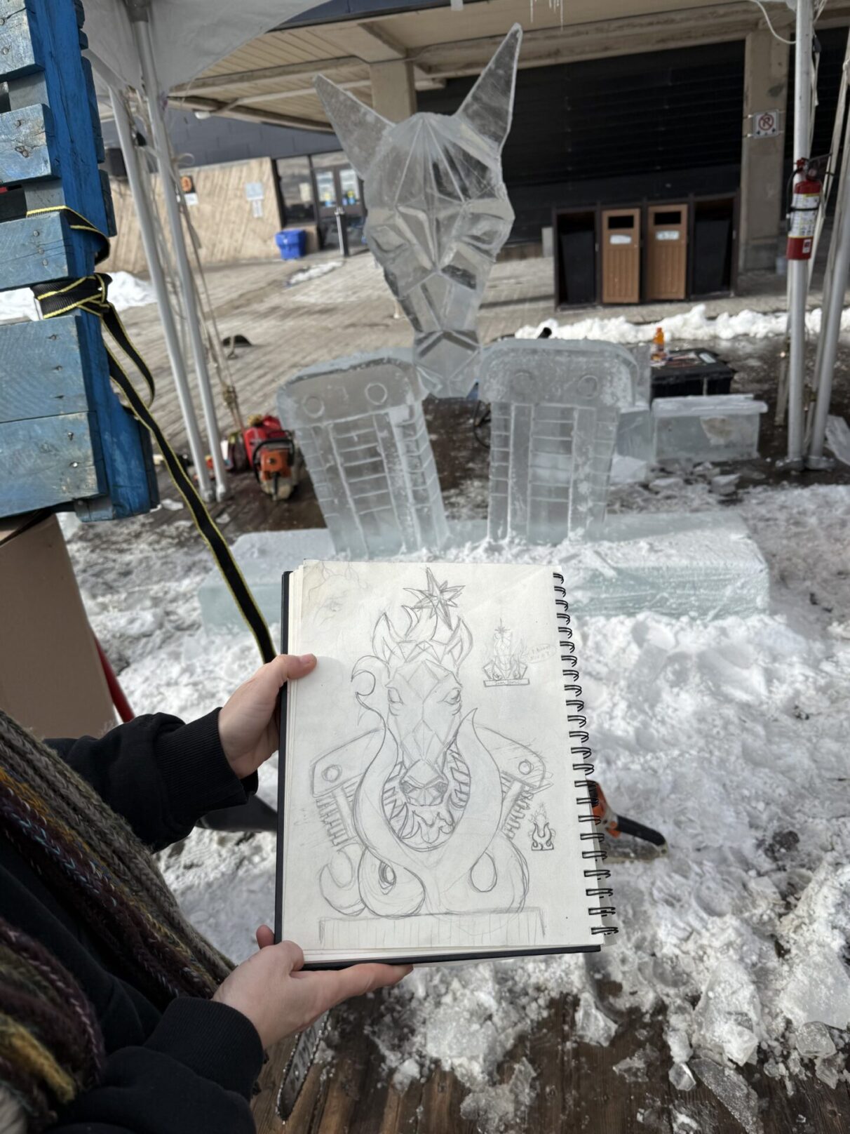 A sketch book shows the design for the ice sculpture pictured in the background by Joel Palmer (Swamp Bear Art)