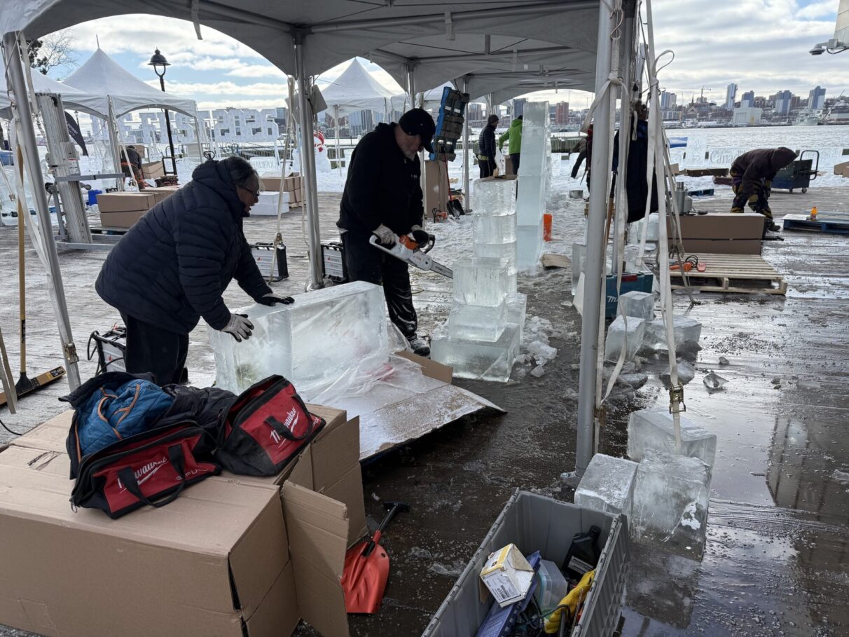 Two ice carvers prep their ice blocks.