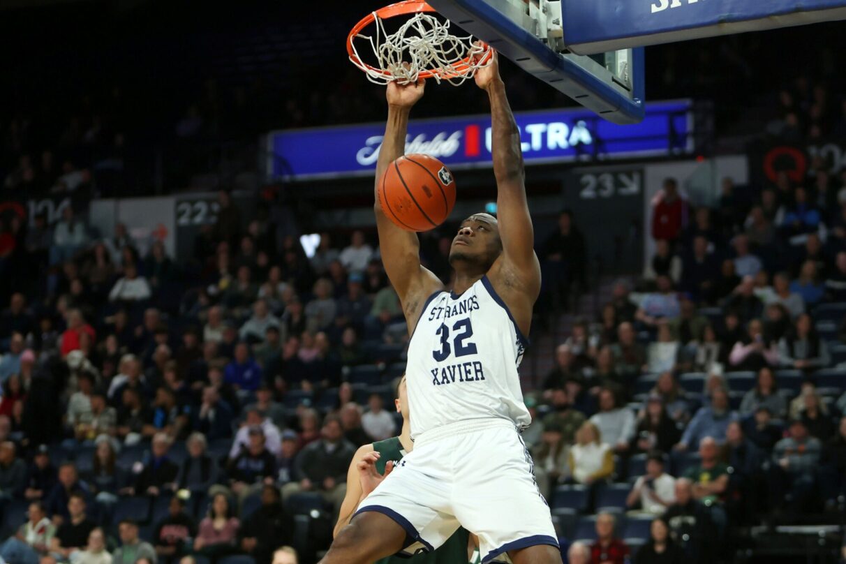 STFX player dunking a basketball during the final of last season's AUS basketball championship.
