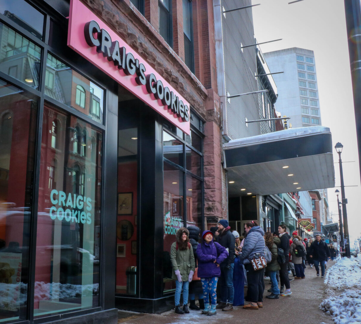 A long line forms in front of the Halifax Craig’s Cookies shop, leading down Barrington Street.