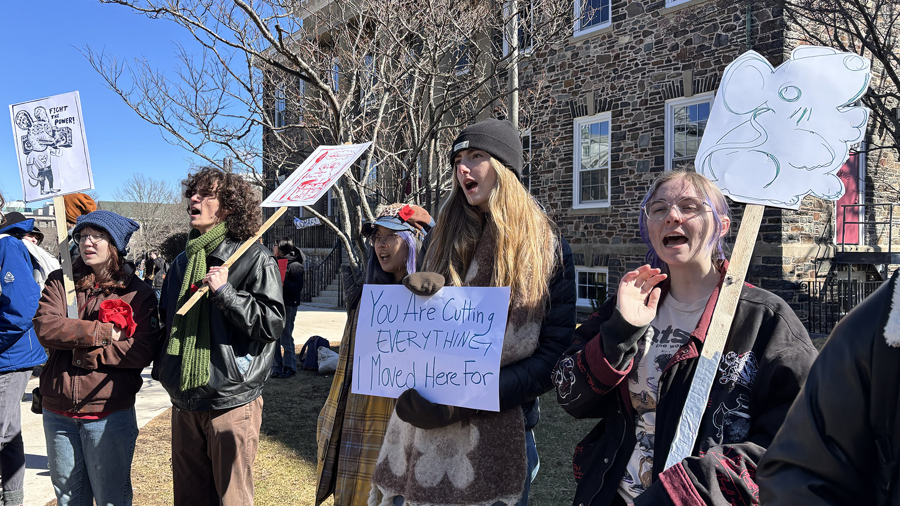 NSCAD students wave protest signs decorated in their student-appointed rat mascot on Studley Campus quad in Halifax, Nova Scotia on March 18, 2026. Students from several Halifax universities gathered for a rally on the third day of the Nova Scotia Student Strike.
