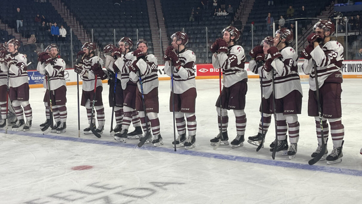 Saint Mary’s Huskies players watch on as UQTR gets awarded the David Johnston University Cup.