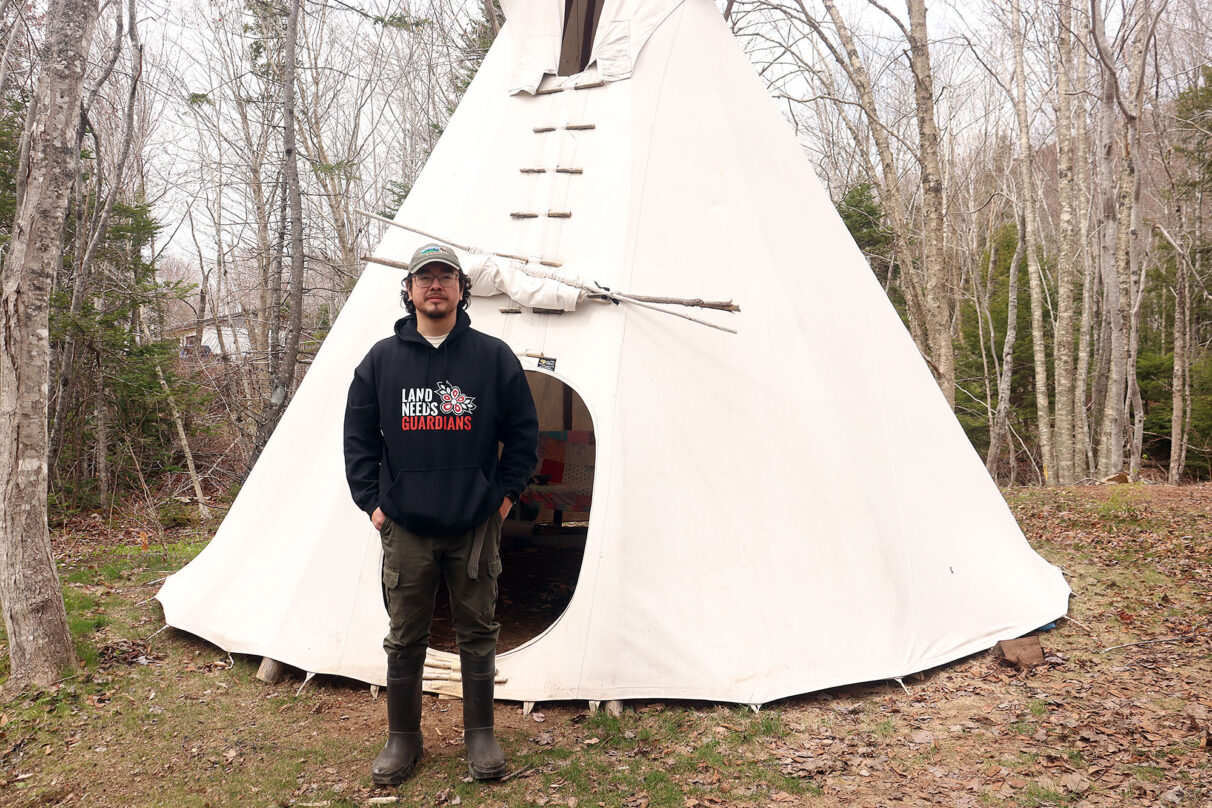 Tony Sylliboy stands in front of a teepee in the cultural grounds of Eskasoni First Nation on May 14, 2026. The teepee took Marshall and Sylliboy 30 minutes to set up.